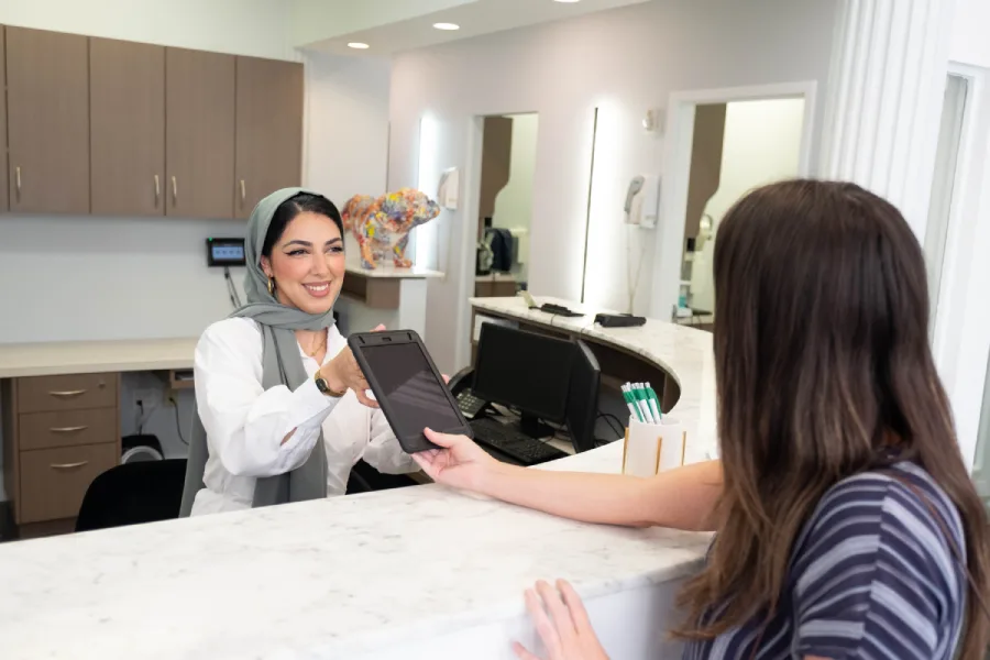 office administrator at Greene Street greeting a patient