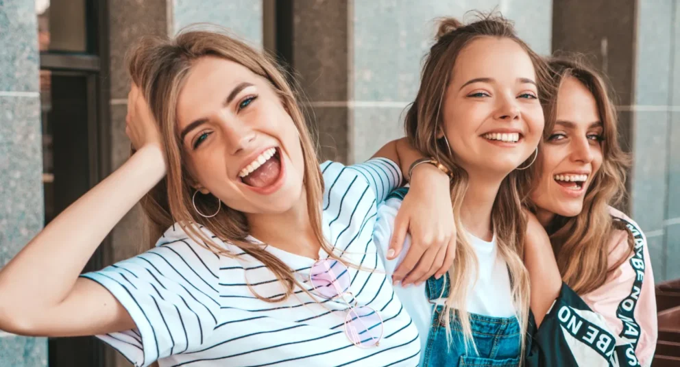 Three young friends smiling and having fun