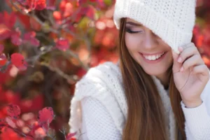 beautiful woman smiling while being outdoors on a flower scenery